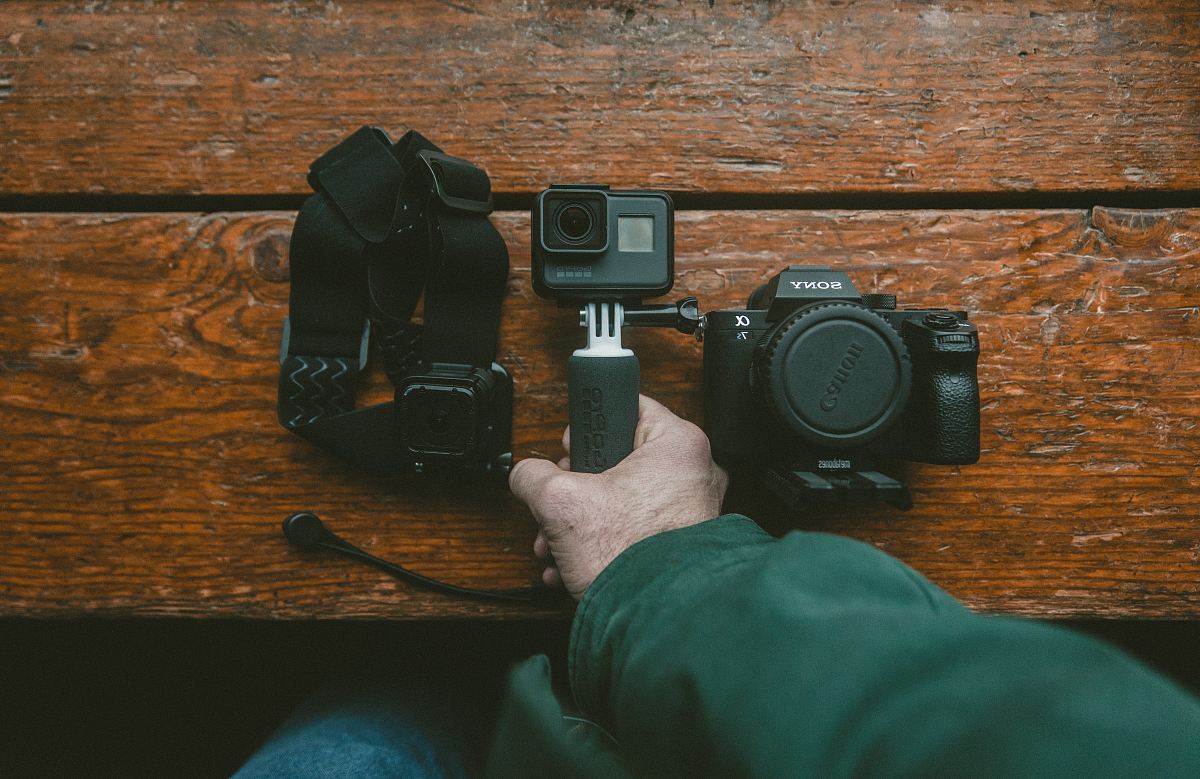 person holding action camera